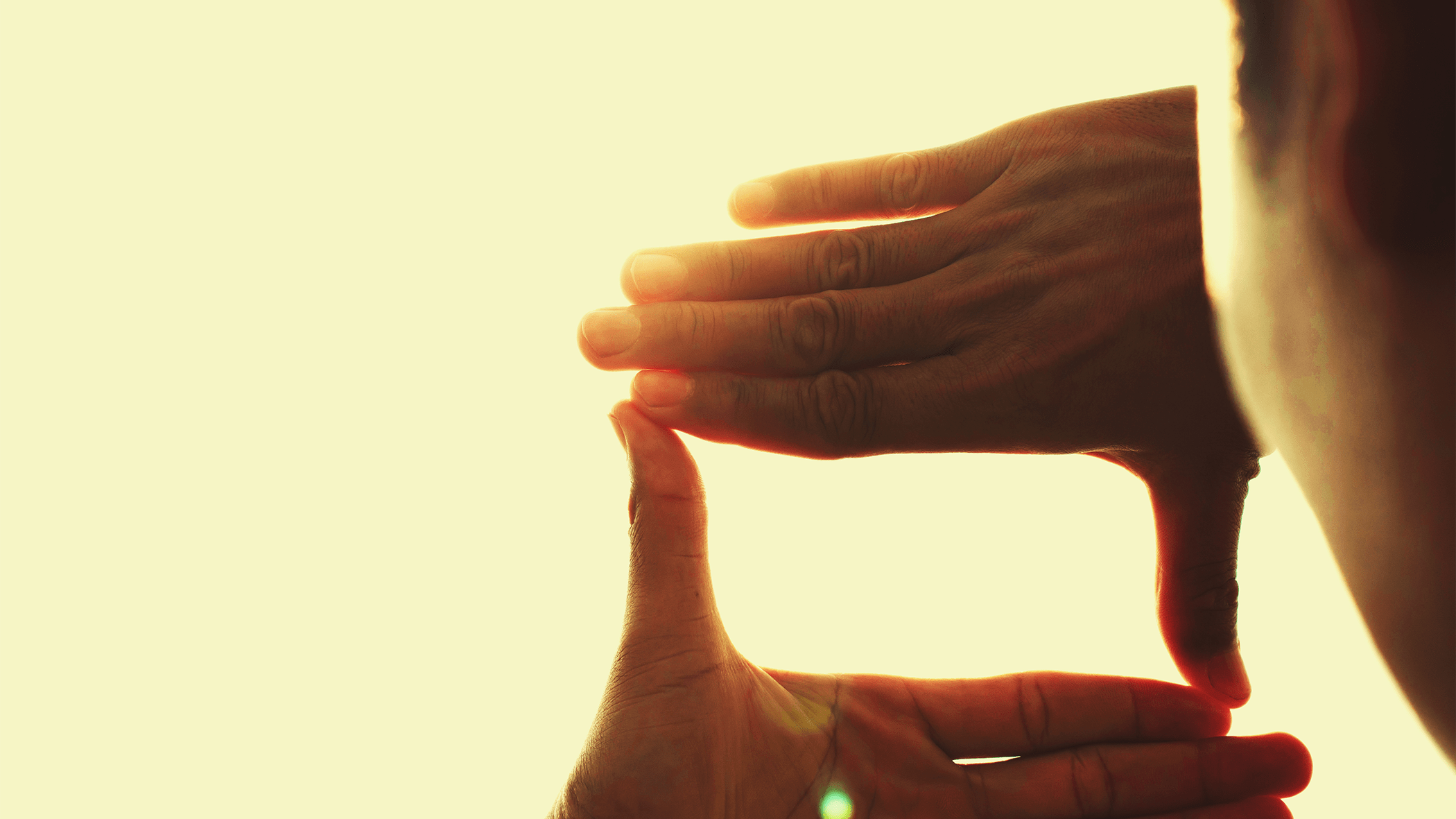 Hands framing sunset